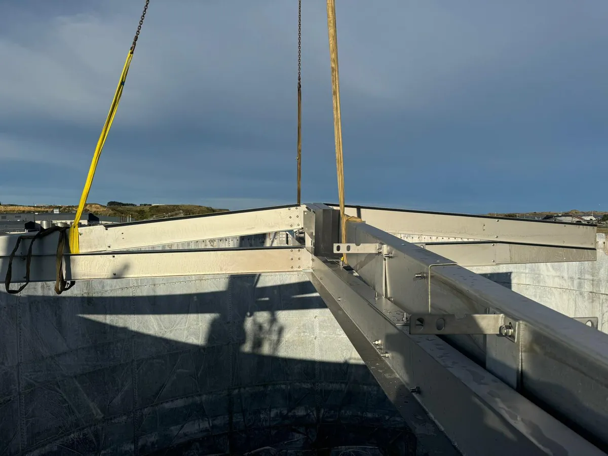 Aluminium roof rafter being lowered onto a tank shell on crane slings